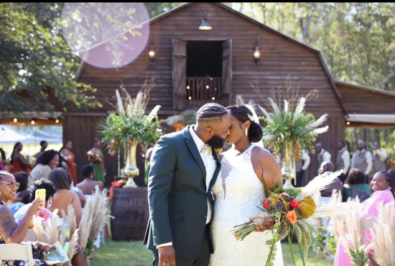 Newlyweds celebrating outdoors in front of the WildHorse barn